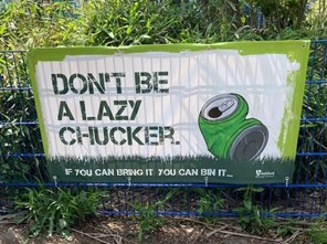 Banner on railing with words Don't be a lazy Chucker and green drinks can