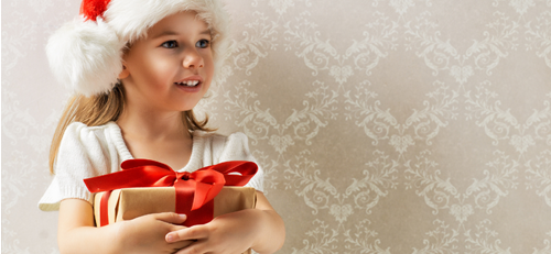 Little girl holding a Christmas present