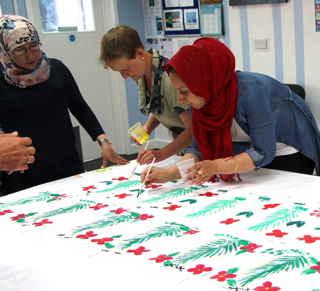 photo from the Syrian Home Project with one attendee painting