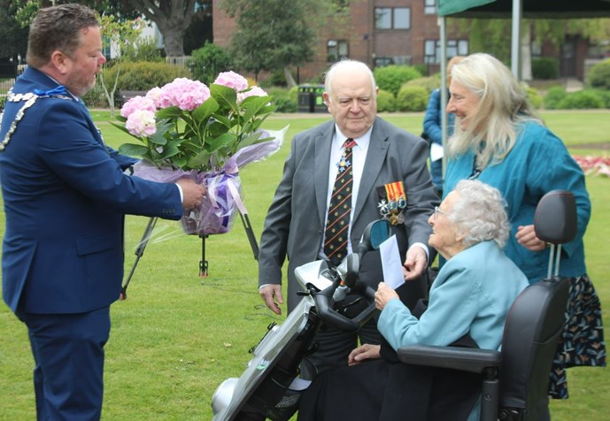 Joyce Dawes receiving flowers from the Mayor of Ashford, Cllr Callum Knowles during her 105th birthday celebrations