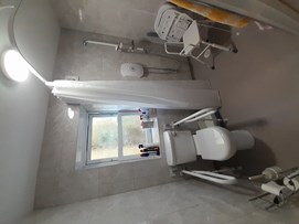 A bathroom with independent aids and adaptations