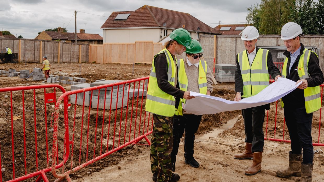 Studying the design plans for the four new houses are, from left to right, ABC Cllr Steve Campkin; ABC Cllr Al Arnold; Ian Collins from Employer’s Agent Calford Seaden; and Aaron Brice, Site Manager for Jenner.