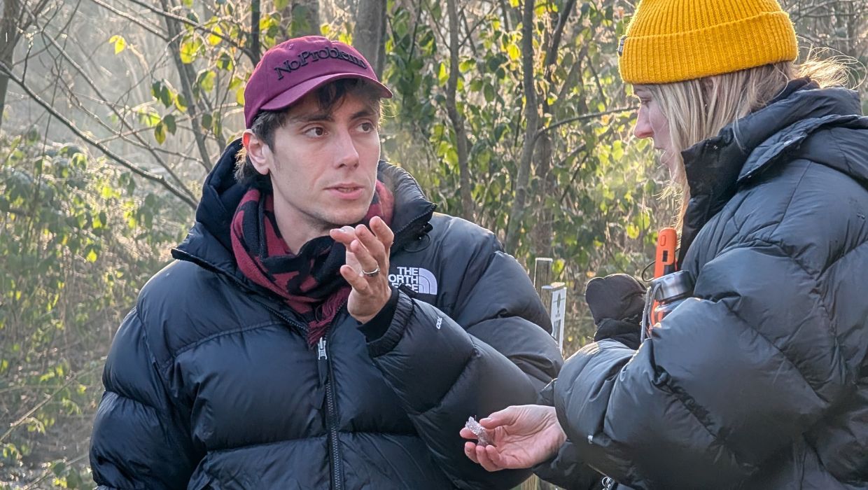 A man and a women talking in a nature reserve with trees in the background