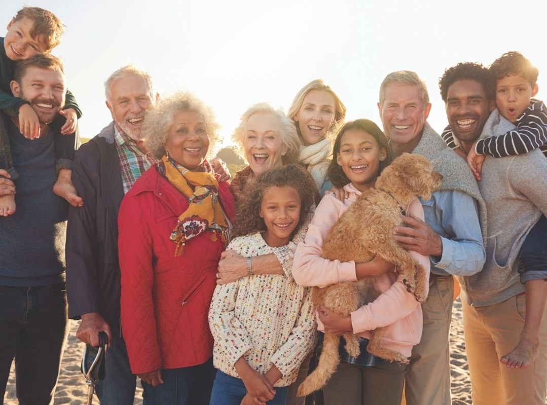 A group of happy people together at a beach