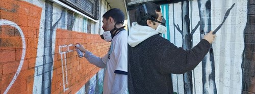 Artists working on the mural in Victoria Park